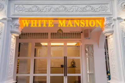 a sign on the door of a white mansion at White Mansion Penang in George Town