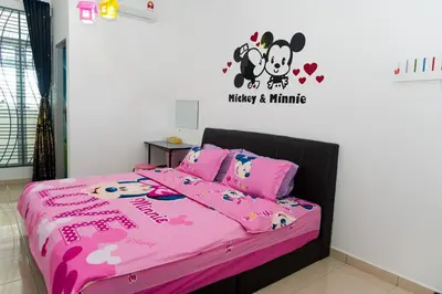 a bedroom with a pink bed with a hello kitty comforter at Qstay Sitiawan Townhouse (Minnie Dreams) - \u7c73\u59ae\u68a6 in Sitiawan