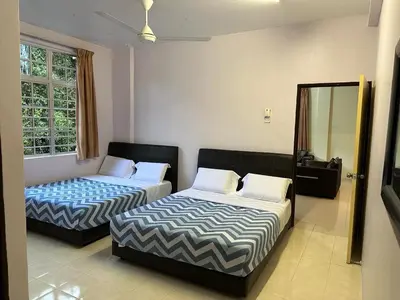a bedroom with two beds and a mirror at Mag Homestay at Crown Imperial Court, Brinchang in Cameron Highlands