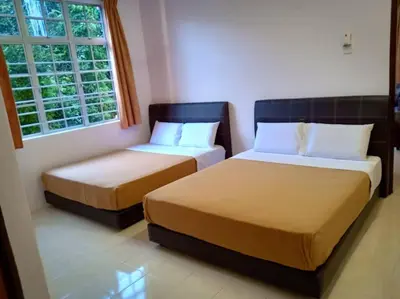 a bedroom with two beds and a window at Mag Homestay at Crown Imperial Court, Brinchang in Cameron Highlands
