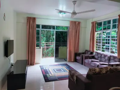 a living room with a couch and a tv at Mag Homestay at Crown Imperial Court, Brinchang in Cameron Highlands