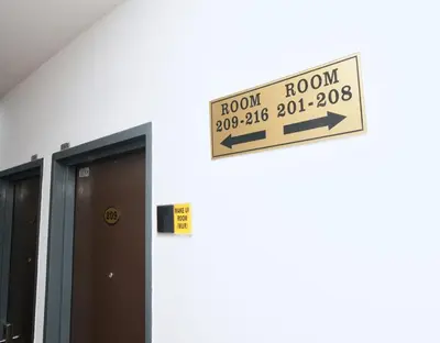 a sign on the side of a building that says room at Grand Inn Hotel - Macalister Road in George Town