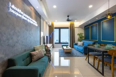 a living room with blue couches and a table at Tropicana 218 Macalister in George Town