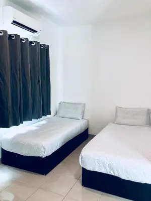 a room with two beds and a curtain at LunaStay (Shared Common Area) in Lunas