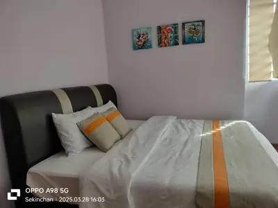 a bedroom with a bed with an orange stripe on it at Sekinchan HighView Penthouse 15pax 5R5B \u9876\u5c42\u516c\u5bd3 \u770b\u6d77 \u770b\u7a3b\u7530\u666f in Sekincan