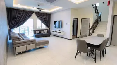 a living room with a couch and a table with chairs at Sekinchan HighView Penthouse 15pax 5R5B \u9876\u5c42\u516c\u5bd3 \u770b\u6d77 \u770b\u7a3b\u7530\u666f in Sekincan