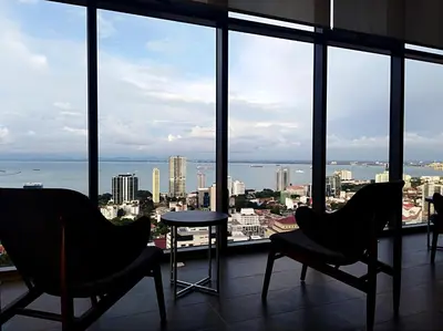 a room with two chairs and a view of the city at Georgetown City View Condo Tropicana 218 Macalister in George Town