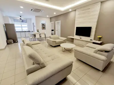 a living room with two couches and a television at 3 Concordia @ Gurney in George Town