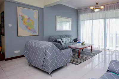 a living room with a couch and a table at Fun Apartment @ Equatorial Hill Resort in Cameron Highlands