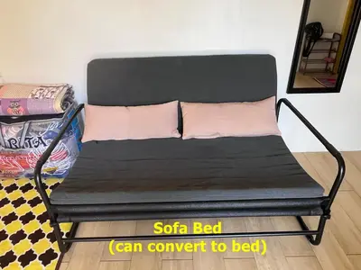 a black bed with two pink pillows on it at Purple Cube at Lumut Cube Homestay Kontena in Lumut