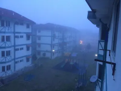 a view from a window of a building in the fog at D'Puncak Arabella Muslim Homestay in Cameron Highlands