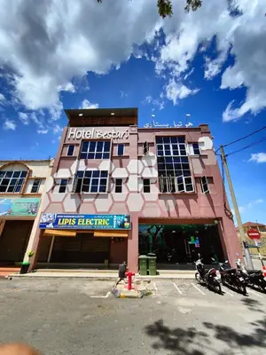 a hotel building with motorcycles parked in front of it at Hotel Bestari in Kuala Lipis