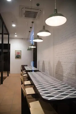 a dining room with a long table with benches at Kooning in George Town
