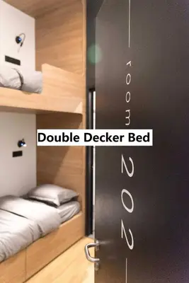 a bedroom with a double decker bed and a door at Kooning in George Town
