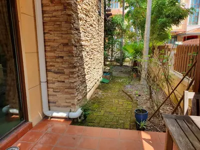 an outside corner of a house with a brick wall at Eden Cosy Living in Batu Ferringhi