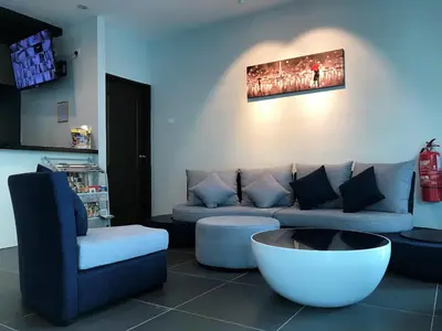 a living room with a couch and a coffee table at Gergasi Inn in Ipoh