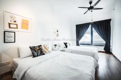 a bedroom with two beds and a ceiling fan at Xandra's 218 Macalister Suite in George Town
