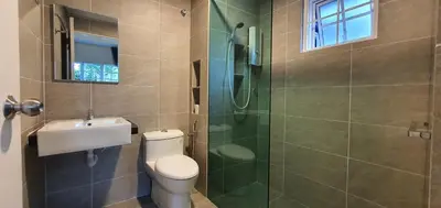 a bathroom with a toilet and a glass shower at Gerard's 