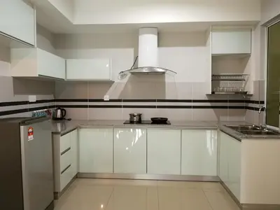 a white kitchen with white cabinets and a sink at Omni Cassia Hill Resort in Cameron Highlands