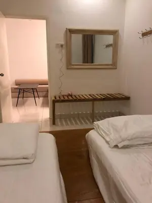 a bedroom with two beds and a mirror and a chair at Brand New Apartment in Local Neighbourhood in Ringlet