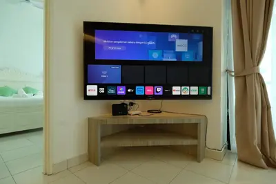a flat screen tv sitting on a wall at Brand New Apartment in Local Neighbourhood in Ringlet