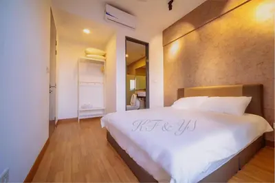 a bedroom with a large white bed with a sign on it at Tropicana 218 Macalister in George Town