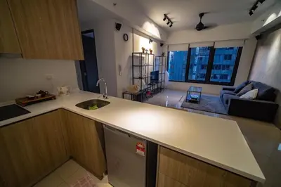 a kitchen with a counter top and a living room at Tropicana 218 Macalister in George Town