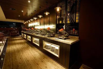 a restaurant with a counter with dishes on it at Jazz Hotel Penang in George Town