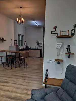 a living room with a couch and a table at Plumber house in Tanah Rata