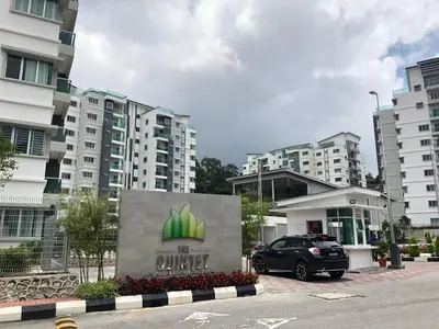 a car parked in a parking lot in front of buildings at Meena's Apartment @ The Quintet in Cameron Highlands