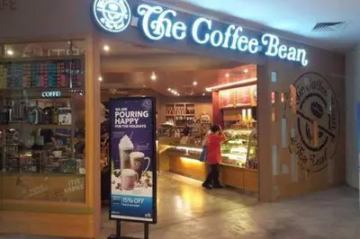 a woman standing in front of a coffee shop at 118 Island Plaza Suite City8 by Joal in Tanjong Tokong