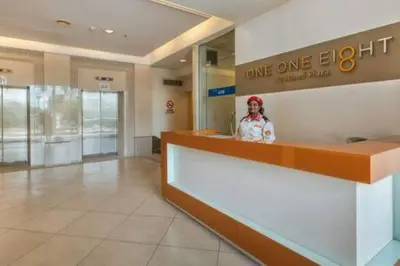 a woman standing behind a counter in a store at 118 Island Plaza Suite City8 by Joal in Tanjong Tokong