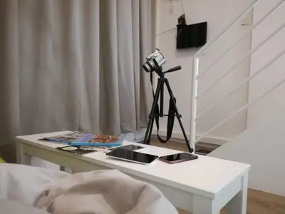 a white coffee table with a camera on a tripod at On Cloud 9 @ CEO by Joal in Bayan Lepas