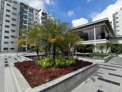 a courtyard with palm trees in front of a building at The Quintet, Tower Ethel in Tanah Rata