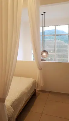 a bedroom with a bed and a large window at Penthouse - Secret Garden de Cameron, Night Market in Tanah Rata