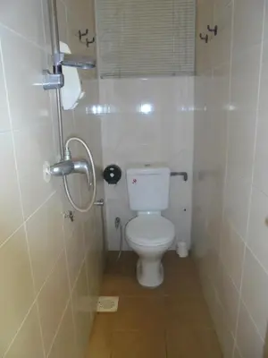 a small bathroom with a toilet and a shower at Moonriver Lodge in Cameron Highlands