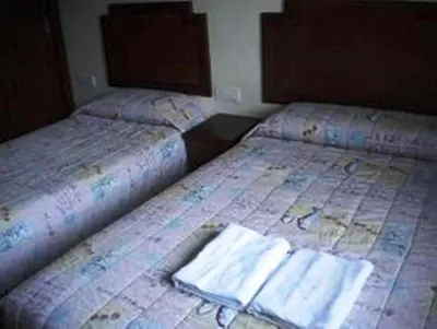two beds sitting next to each other in a room at Jasmine Hotel in Cameron Highlands