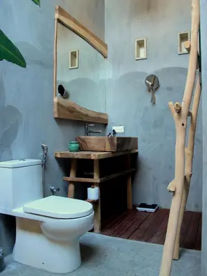 a bathroom with a toilet and a wooden sink at The Happy 8 Retreat in Ipoh
