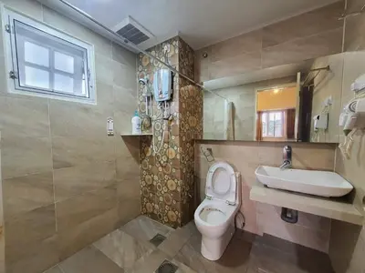 a bathroom with a toilet and a sink at Cameron Greenhill Apartment in Cameron Highlands