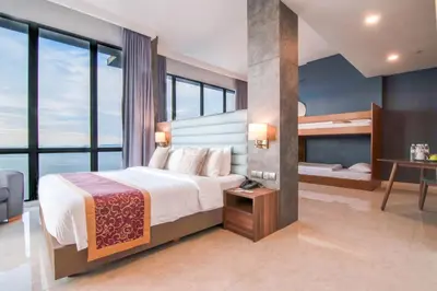 a bedroom with a bed and a bunk bed at Hompton Hotel by the Beach in George Town
