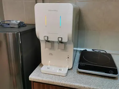 a white appliance sitting on a counter next to a toaster at The Woodz Thematic Homestay - Cameron Highlands Golden Hills Night Market in Cameron Highlands