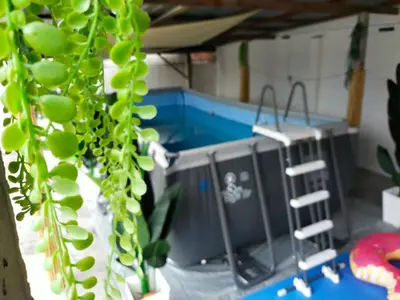 a room with two computer consoles and a plant at beXuan-Private Pool-Town Area-Snooker-BBQ-12-18Pax in Ipoh