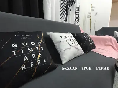 a gray couch with two pillows on it at beXuan-Private Pool-Town Area-Snooker-BBQ-12-18Pax in Ipoh