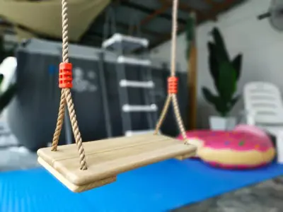 a wooden swing on a table with a doughnut at beXuan-Private Pool-Town Area-Snooker-BBQ-12-18Pax in Ipoh