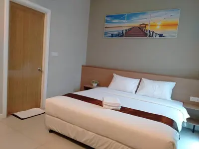 a bedroom with a large bed in a room at MD Boutique Hotel in Kampar