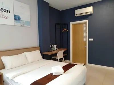 a bedroom with a bed and a desk in it at MD Boutique Hotel in Kampar