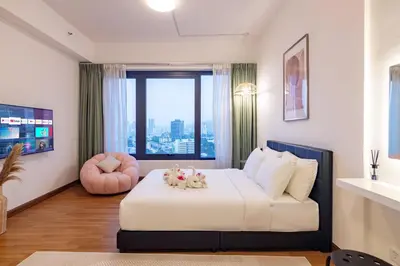a bedroom with a bed with two stuffed animals on it at Tropicana 218 Macalister X Airlevate Suites in George Town