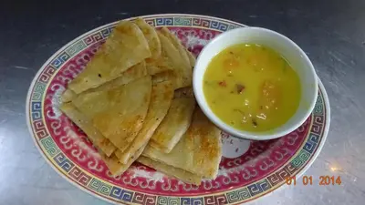 a plate with chips and a bowl of dipping sauce at Seven Terraces in George Town