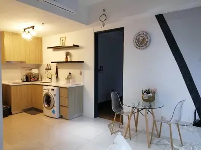 a kitchen with a table and a washing machine in it at 218 Tropicana Georgetown Penang #B30 2BR for 4-7pax\u6e29\u99a8\u7a9d\u8212\u9002\u4e24\u623f in George Town