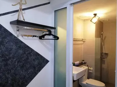 a bathroom with a toilet and a sink and a mirror at 218 Tropicana Georgetown Penang #B30 2BR for 4-7pax\u6e29\u99a8\u7a9d\u8212\u9002\u4e24\u623f in George Town